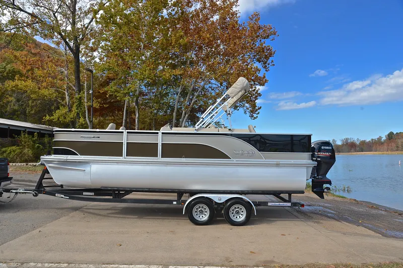 Slide: The Image of 2023 SunCatcher Select 22F pontoon boat on trailer by a scenic lake. - 11