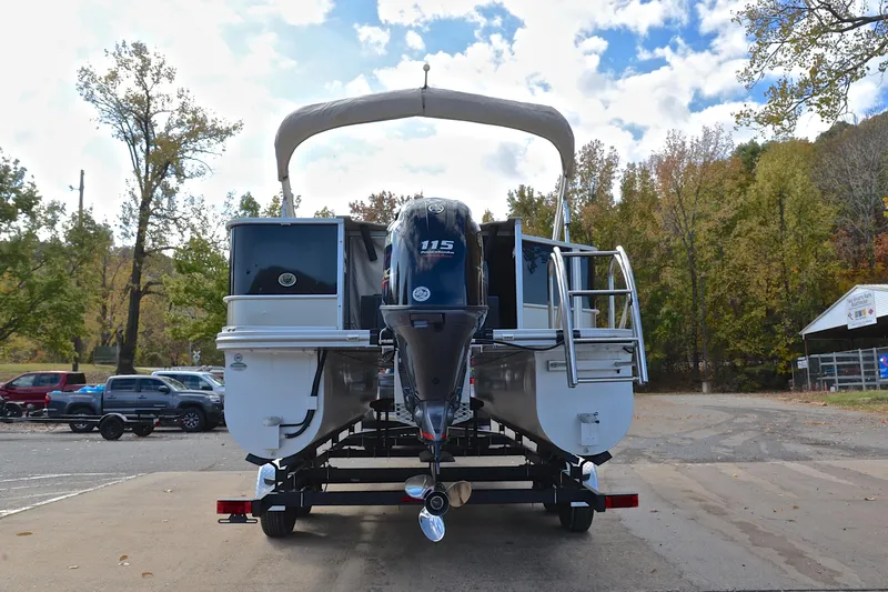Slide: The Image of 2023 SunCatcher Select 22F pontoon boat on trailer, parked outdoors with trees in background. - 13