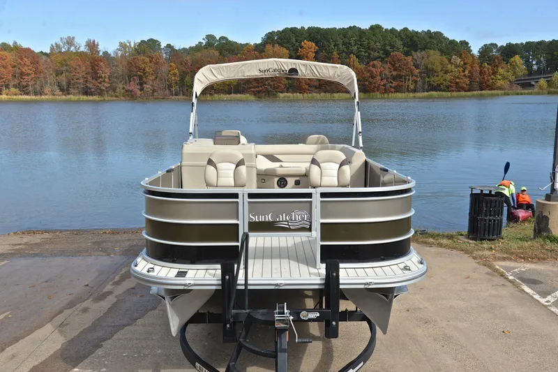 Slide: The Image of 2023 SunCatcher Select 22F pontoon boat by a scenic lake with autumn foliage. - 17