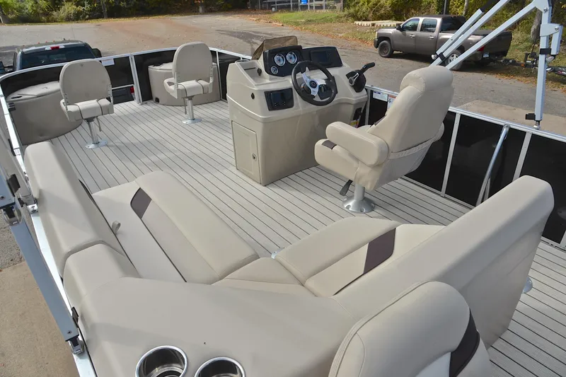 Slide: The Image of 2023 SunCatcher Select 22F pontoon boat interior with beige seating and steering console. - 25