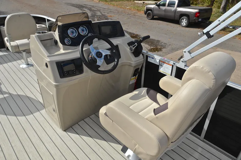 Slide: The Image of 2023 SunCatcher Select 22F boat interior with steering console and beige captain's chair. - 26