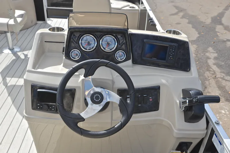 Slide: The Image of 2023 SunCatcher Select 22F boat dashboard with steering wheel and control panel. - 27