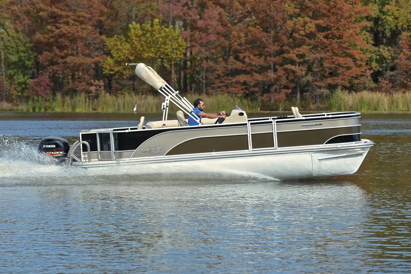 Slide: The Image of 2023 SunCatcher Select 22F pontoon boat cruising on a lake with autumn foliage. - 3