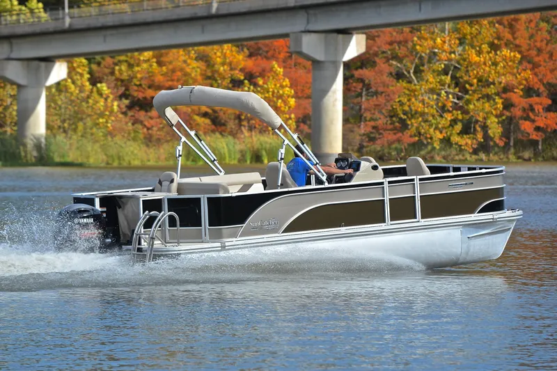 Slide: The Image of 2023 SunCatcher Select 22F pontoon boat cruising on a lake with autumn foliage. - 5