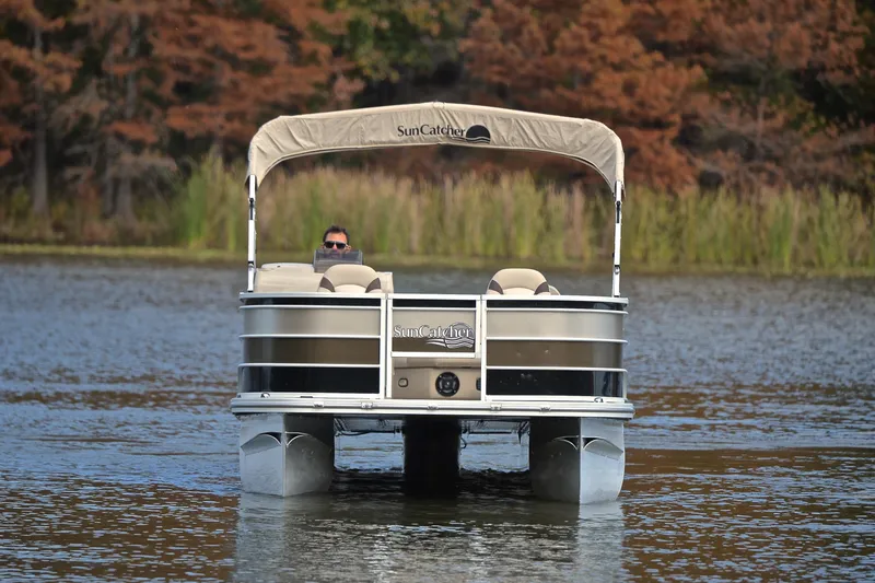 Slide: The Image of 2023 SunCatcher Select 22F pontoon boat on a serene lake with autumn foliage. - 9