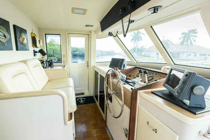 Slide: The Image of Interior of 1987 Hatteras 70 Cockpit Motor Yacht helm with steering wheel and navigation equipment. - 14