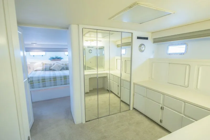 Slide: The Image of Luxurious interior of 1987 Hatteras 70 Cockpit Motor Yacht with mirrored closet and cozy bedroom. - 18