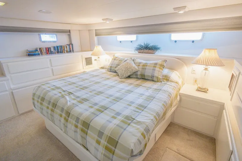 Slide: The Image of Luxurious bedroom in 1987 Hatteras 70 Cockpit Motor Yacht with plaid bedding and elegant decor. - 20