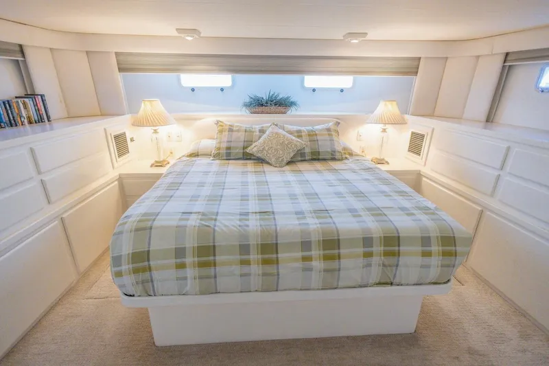 Slide: The Image of Luxurious bedroom interior of 1987 Hatteras 70 Cockpit Motor Yacht with plaid bedding. - 21