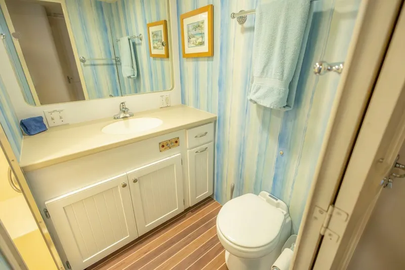 Slide: The Image of Bathroom interior of 1987 Hatteras 70 Cockpit Motor Yacht with striped wallpaper. - 29