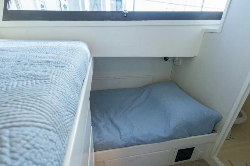 Slide: The Image of Interior cabin of 1987 Hatteras 70 Cockpit Motor Yacht with blue bedding. - 31