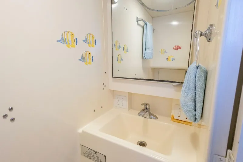 Slide: The Image of Bathroom of 1987 Hatteras 70 Cockpit Motor Yacht with fish decals and towel. - 32