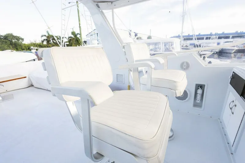 Slide: The Image of White seating on 1987 Hatteras 70 Cockpit Motor Yacht deck, featuring modern design. - 36