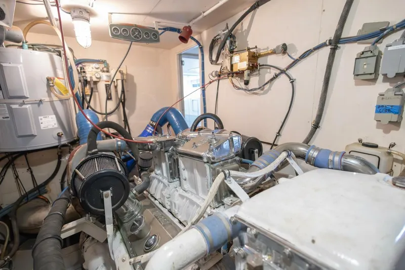 Slide: The Image of Engine room of 1987 Hatteras 70 Cockpit Motor Yacht with visible machinery and wiring. - 39