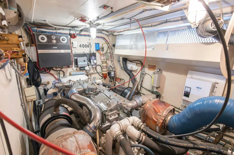 Slide: The Image of Engine room of 1987 Hatteras 70 Cockpit Motor Yacht with complex machinery and wiring. - 43