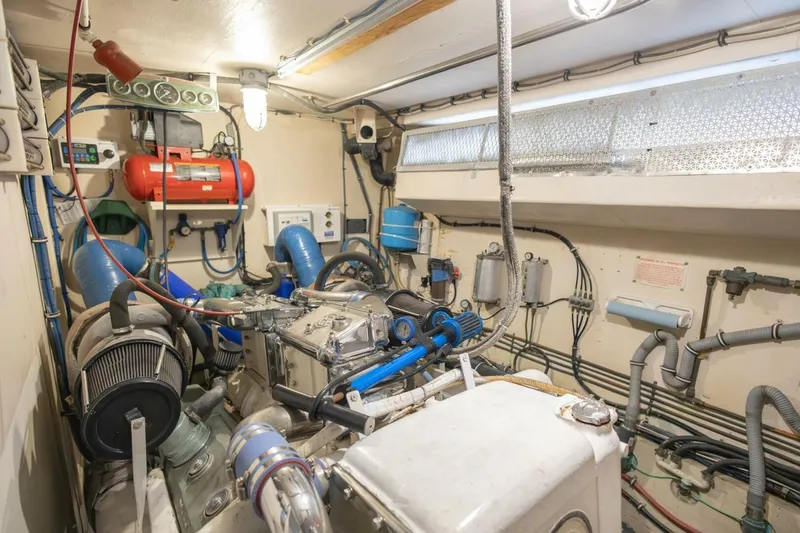 Slide: The Image of Engine room of 1987 Hatteras 70 Cockpit Motor Yacht, showcasing mechanical components and systems. - 45
