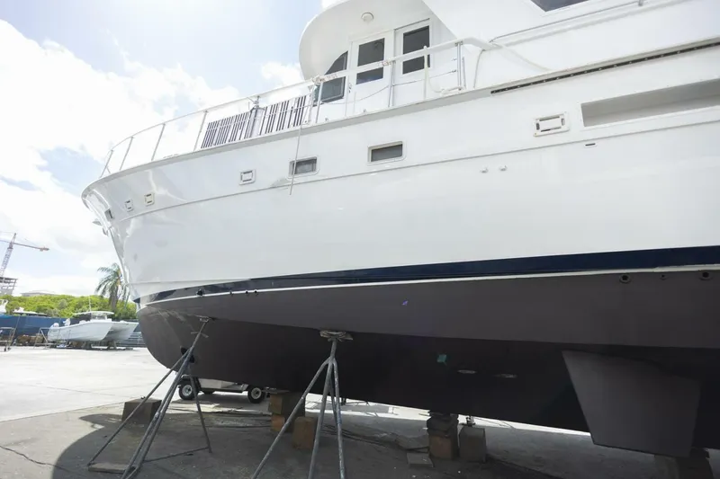 Slide: The Image of 1987 Hatteras 70 Cockpit Motor Yacht on dry dock, side view. - 49