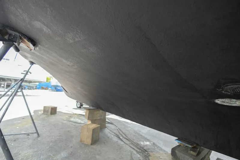 Slide: The Image of Bottom view of 1987 Hatteras 70 Cockpit Motor Yacht on dry dock. - 52