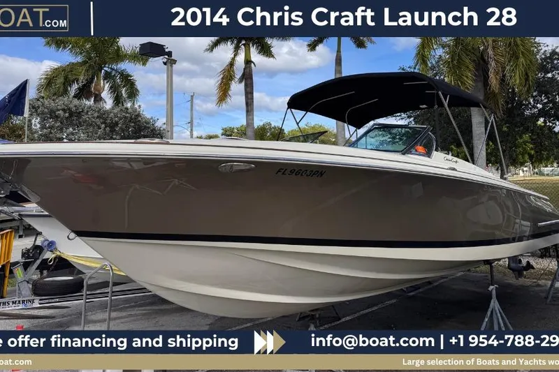 The Image of 2014 Chris-Craft Launch 28 boat displayed outdoors with palm trees in the background. - 0