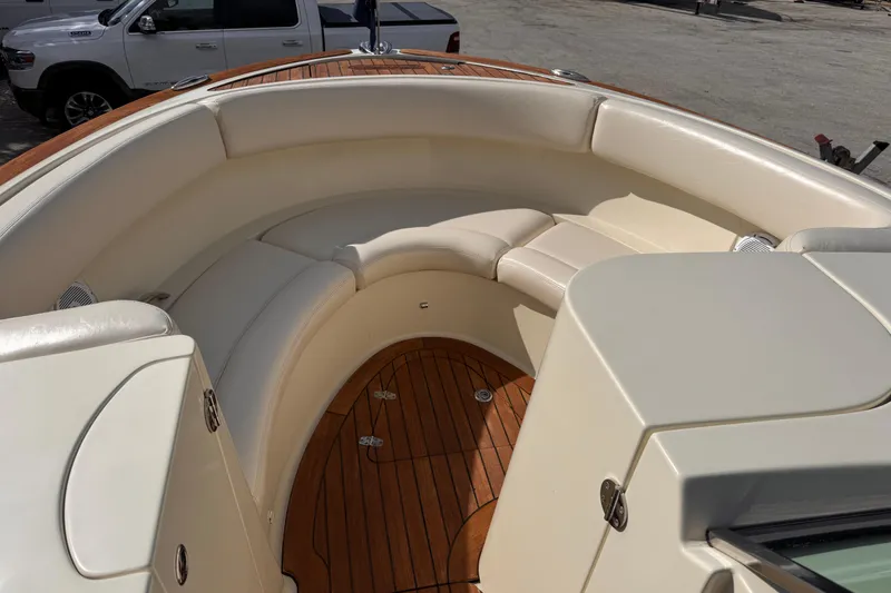 Slide: The Image of 2014 Chris-Craft Launch 28 boat interior with cream seating and wooden flooring. - 17
