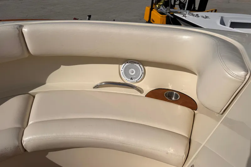 Slide: The Image of 2014 Chris-Craft Launch 28 boat interior with beige leather seating and speaker. - 18