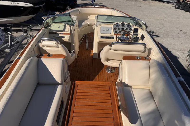 Slide: The Image of 2014 Chris-Craft Launch 28 boat interior with luxurious seating and wooden accents. - 22