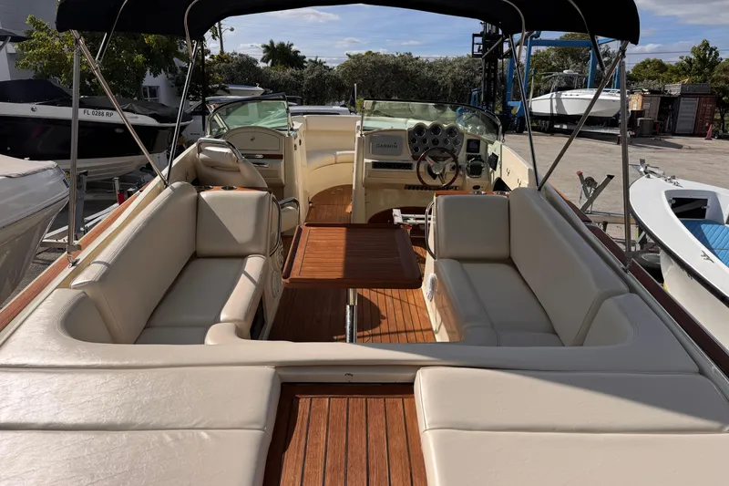 Slide: The Image of 2014 Chris-Craft Launch 28 boat interior with beige seating and wooden flooring. - 9