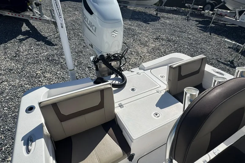Slide: The Image of 2022 Aquasport 230 Pro Bay boat with Suzuki outboard motor, rear seating, and cup holders. - 11
