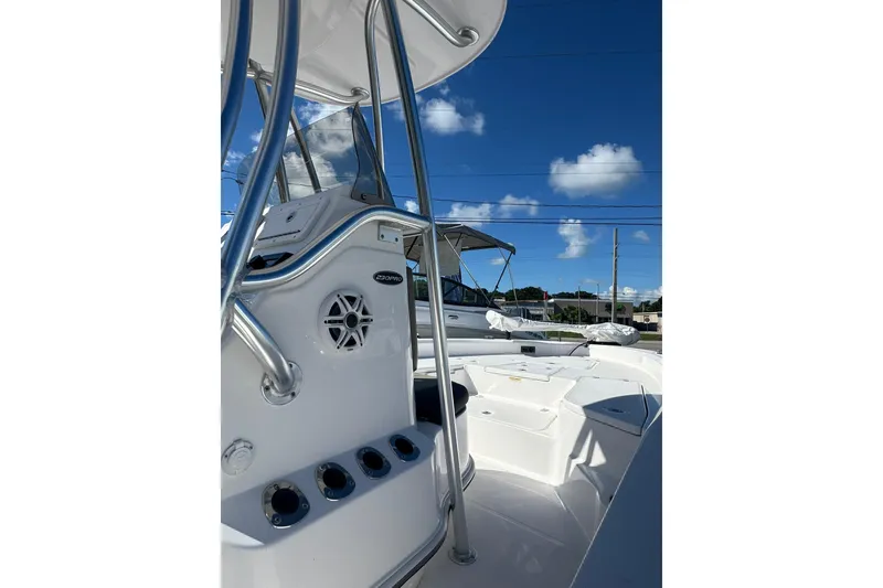 Slide: The Image of 2022 Aquasport 230 Pro Bay boat with sleek design and modern features under a clear blue sky. - 3