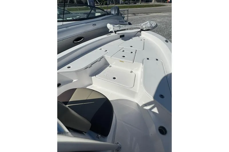 Slide: The Image of 2022 Aquasport 230 Pro Bay boat deck with storage compartments and seating. - 4