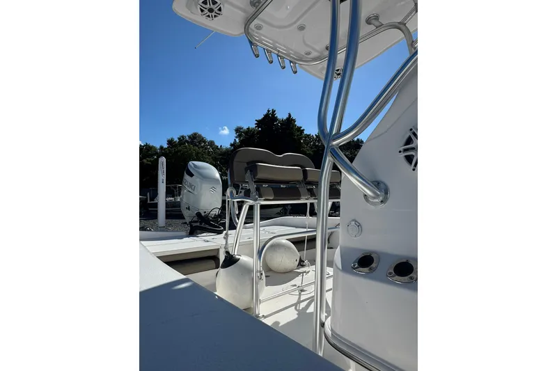 Slide: The Image of 2022 Aquasport 230 Pro Bay boat with Suzuki outboard motor, sunny day. - 5