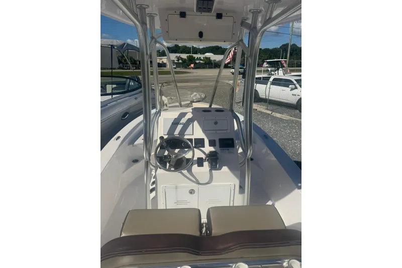 Slide: The Image of 2022 Aquasport 230 Pro Bay boat interior with steering console and seating. - 8