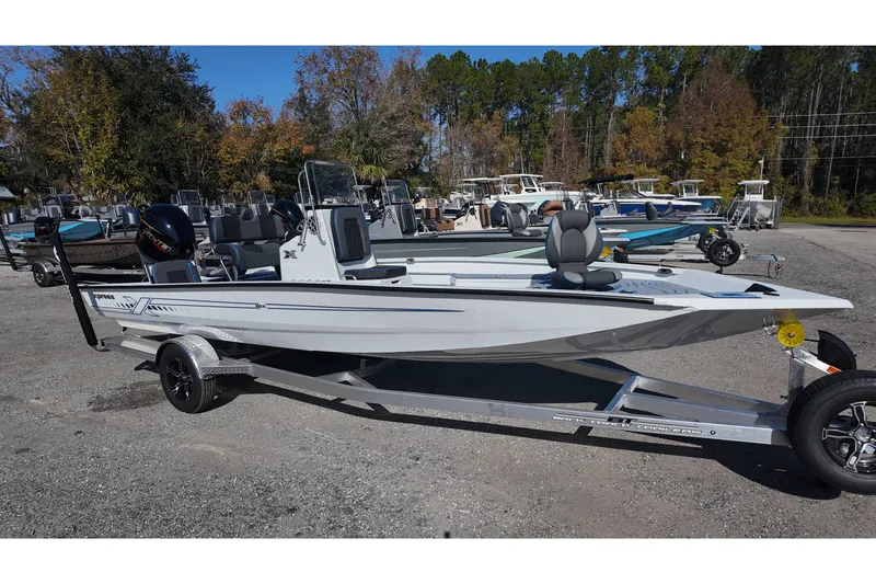 The Image of 2026 Xpress H22B Bay boat on trailer, parked outdoors with trees in background. - 0