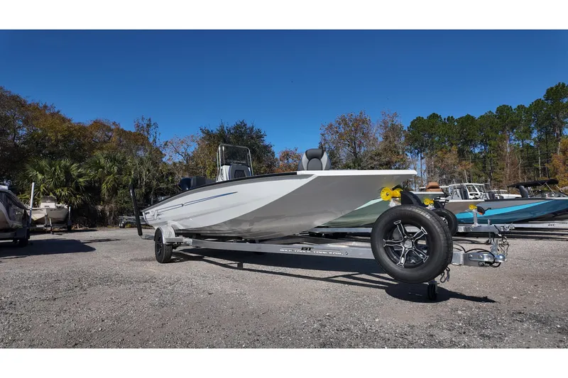 Slide: The Image of 2026 Xpress H22B Bay boat on trailer, parked outdoors under clear blue sky. - 3