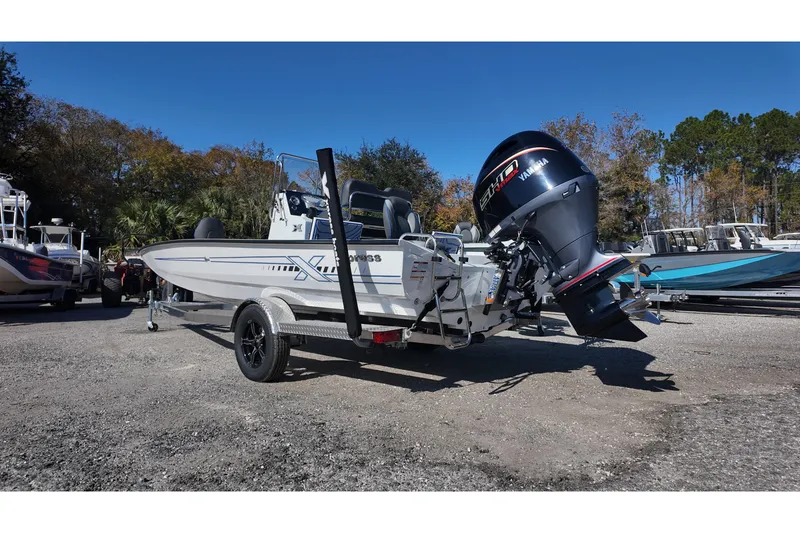 Slide: The Image of 2026 Xpress H22B Bay boat on trailer with Yamaha outboard motor, parked outdoors. - 4