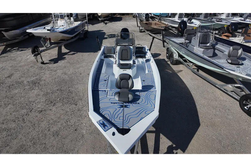 Slide: The Image of 2026 Xpress H22B Bay boat with modern design, parked on gravel lot. - 8
