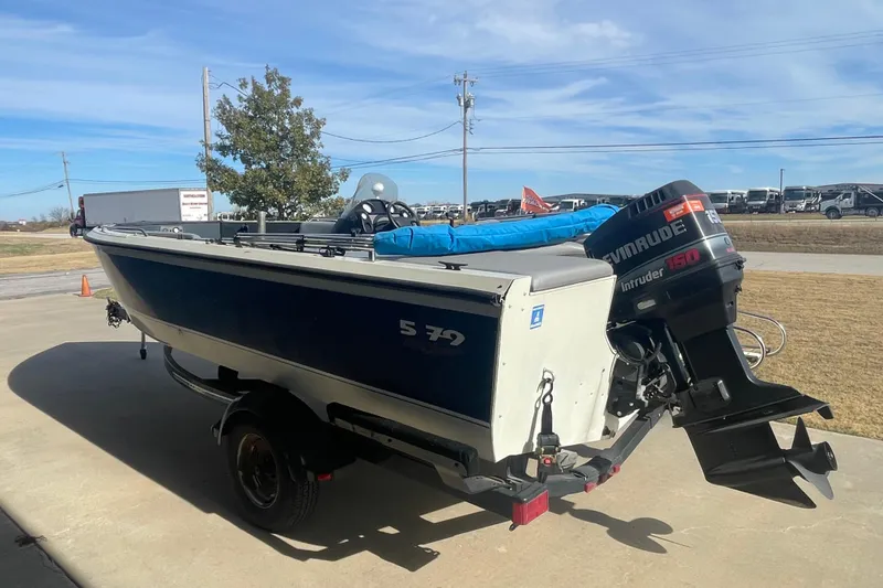 Slide: The Image of 1997 Lowe Classic 257 boat with Evinrude 150 motor on a trailer. - 2