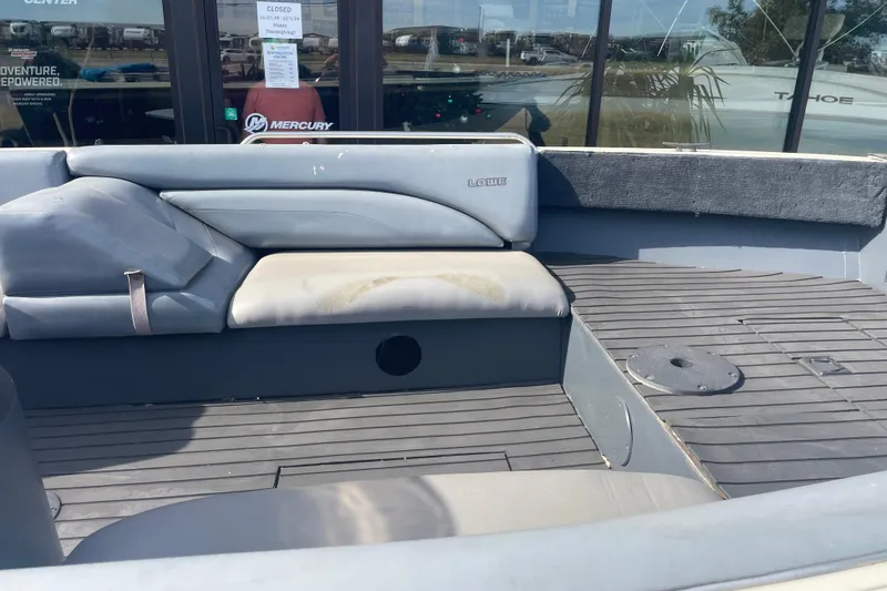 Slide: The Image of 1997 Lowe Classic 257 boat interior with gray seating and flooring. - 4