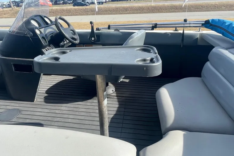 Slide: The Image of 1997 Lowe Classic 257 boat interior with steering wheel and seating area. - 6