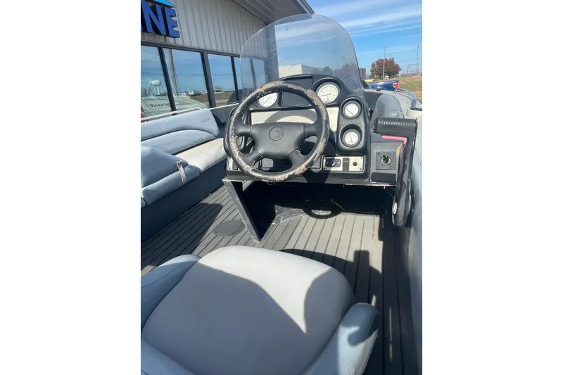 Slide: The Image of 1997 Lowe Classic 257 boat interior with steering wheel and dashboard controls. - 8