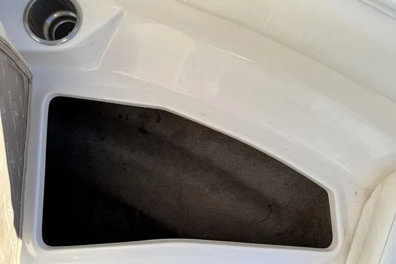 Slide: The Image of Storage compartment in a 2006 Regal 2000 boat, featuring a clean white interior. - 10