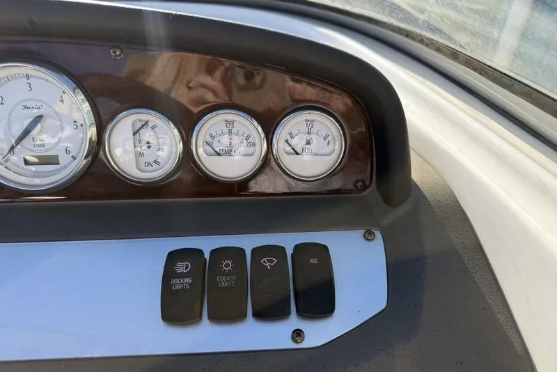 Slide: The Image of Dashboard of a 2006 Regal 2000 boat with gauges and control switches. - 11