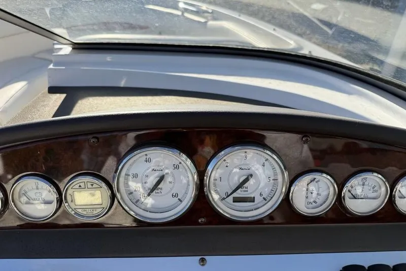 Slide: The Image of Dashboard of a 2006 Regal 2000 boat with various gauges and controls. - 13