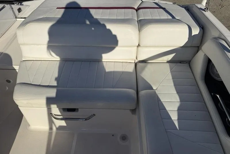 Slide: The Image of White leather seating on a 2006 Regal 2000 boat, shadow cast on cushions. - 18
