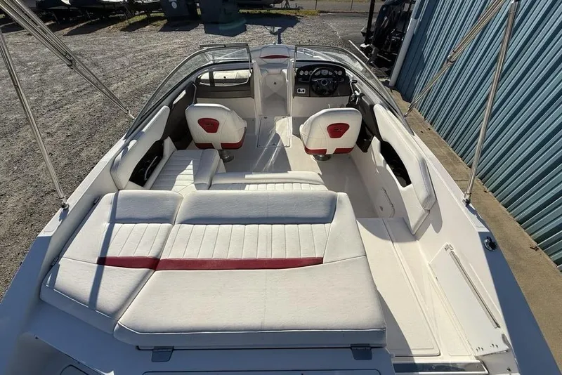 Slide: The Image of 2006 Regal 2000 boat interior with white and red seating, steering console, and open deck. - 25
