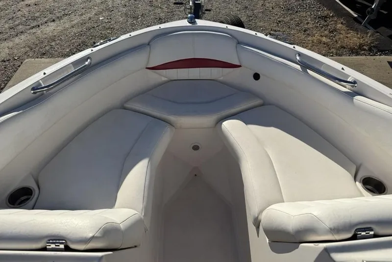 Slide: The Image of Interior of a 2006 Regal 2000 boat with white seating and cup holders. - 3