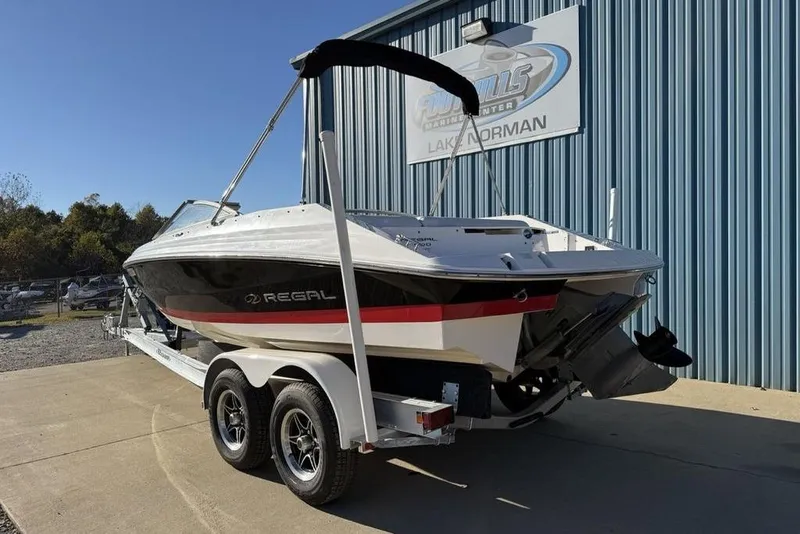 Slide: The Image of 2006 Regal 2000 boat on trailer outside marine center, sunny day. - 4