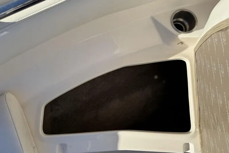 Slide: The Image of Storage compartment in a 2006 Regal 2000 boat, featuring a sleek white interior. - 7