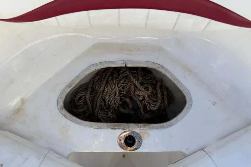 Slide: The Image of Storage compartment with coiled rope in a 2006 Regal 2000 boat. - 8