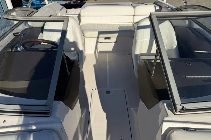 Slide: The Image of Interior of a 2006 Regal 2000 boat with white seating and dual consoles. - 9